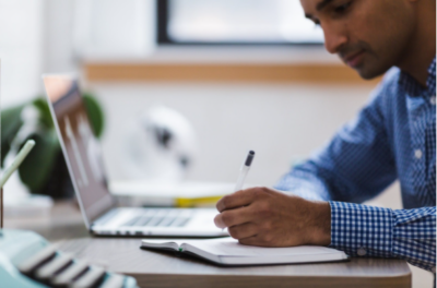 Man working at desk reviewing human resources paperwork 